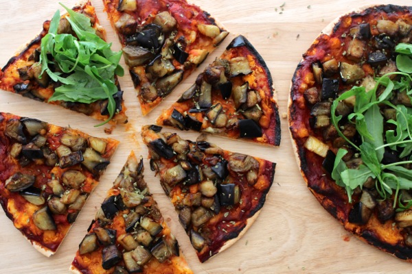 Vegan aubergine, oregano and white bean pizza topped with arugula Vegan aubergine, oregano and white bean pizza topped with arugula