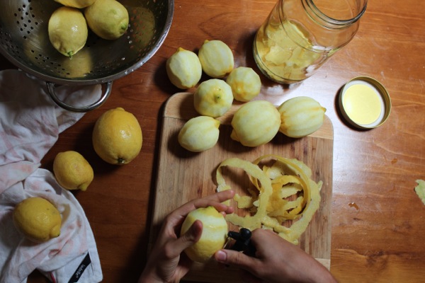 Peeling lemon rind to make limoncello