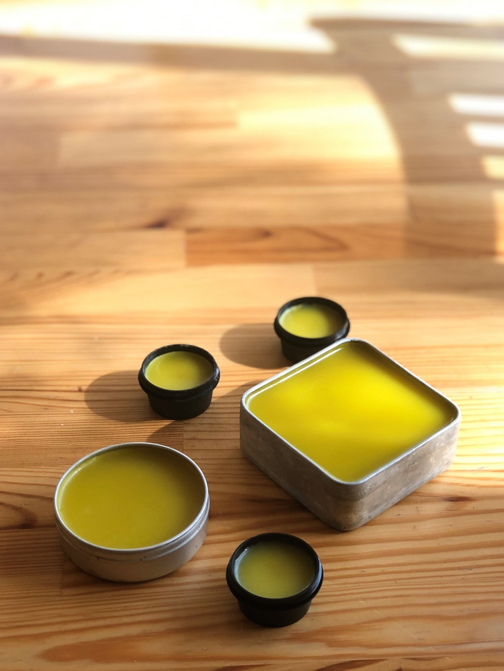 An assortment of pots filled with calendula salve.