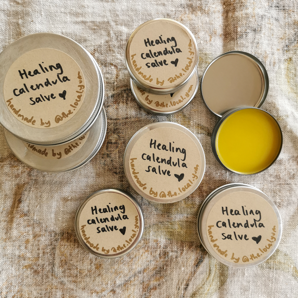 Pots of completed calendula salve.